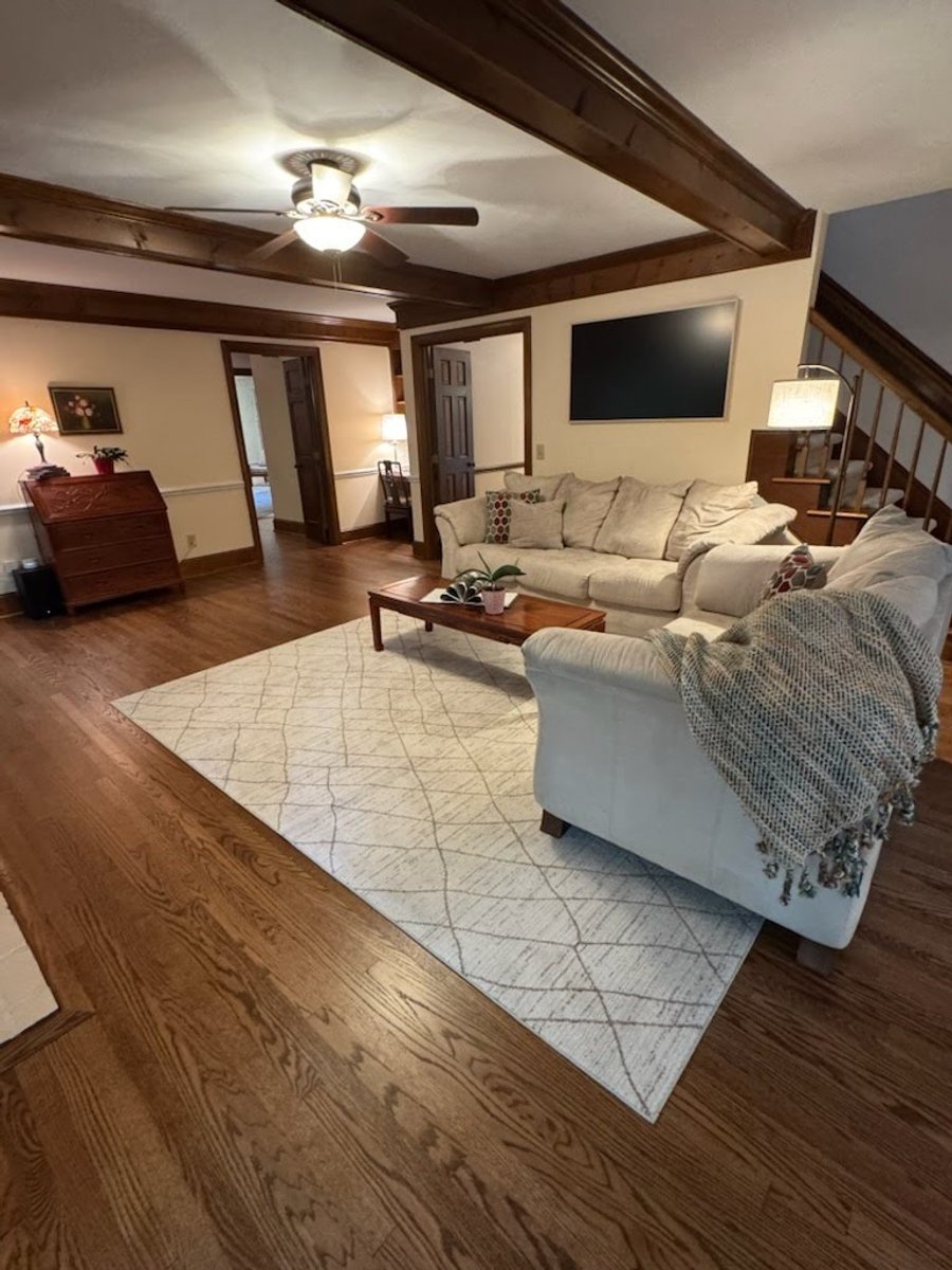 A living room with wood beams, after staging