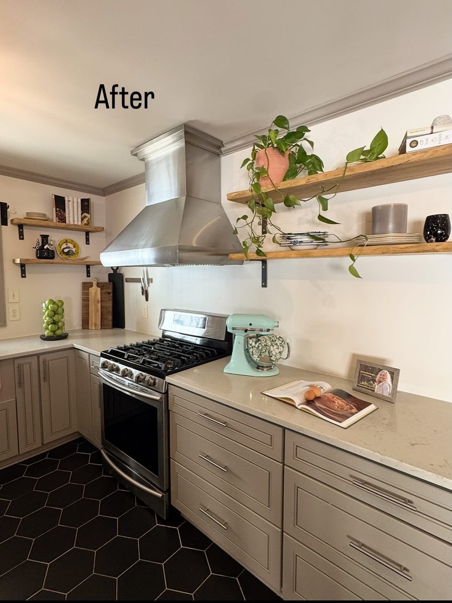A kitchen with black tile floors, after staging