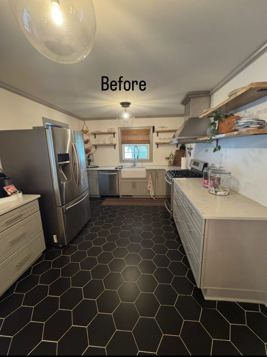 A kitchen with black tile floors, before staging