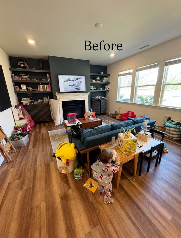 A family room with a fireplace before styling