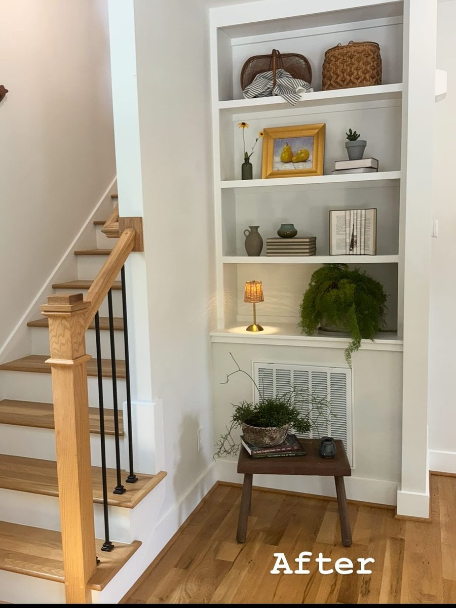 A built-in shelf by the stairs, after staging