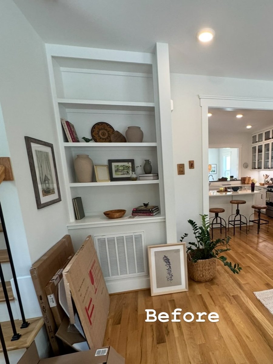 A built-in shelf by the stairs, before staging